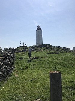 Kvitsøy lighthouse and ancient beacon behind Jon Erik